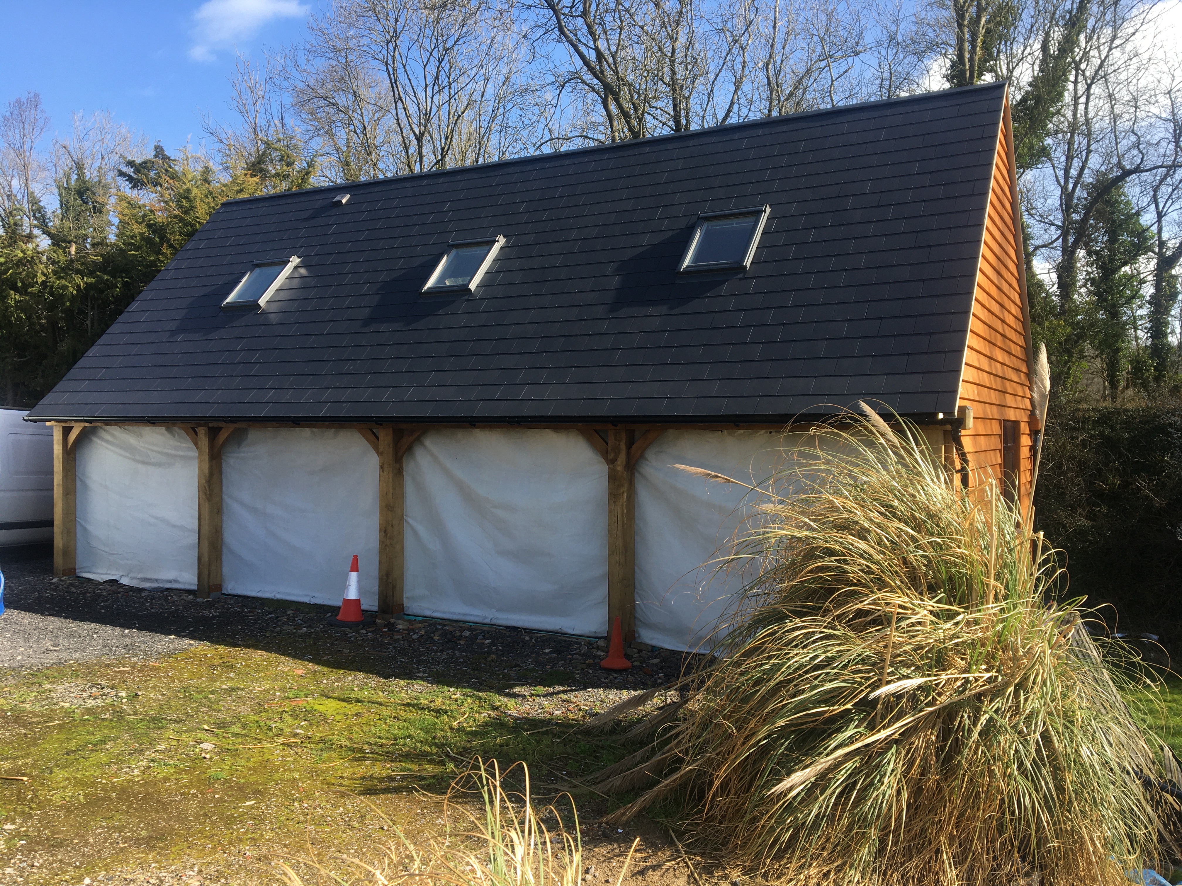 New-build oak-framed garage outbuilding with slate roof